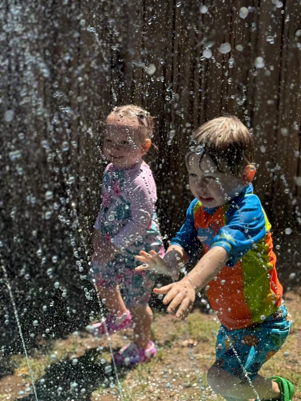 Dean playing with water outside